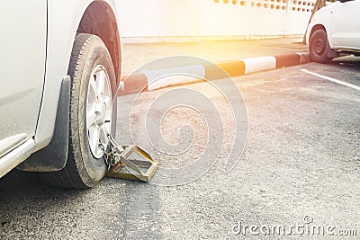 Locked wheel of car.Car wheel lock for parking in a place not allowed by the police. Prohibited Stock Photo