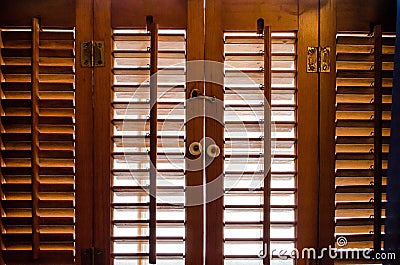 Locked wooden window shutters from the inside Stock Photo