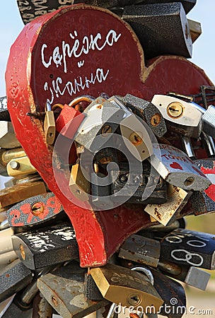 Locking padlocks with written names of just married couple and throwing away key is common wedding ceremony and tradition as symbo Editorial Stock Photo