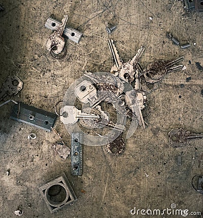 Locksmith background with old keys and lock parts in an abandoned workshop Stock Photo