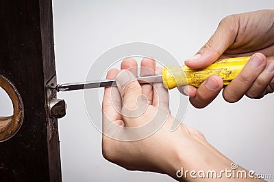 Locksmith fix lock on wooden door Stock Photo