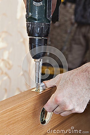 Locksmith fixing latch and lock knob wood interior door. Stock Photo