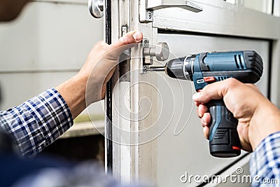 Locksmith Lock Door Repair. Worker Changing Stock Photo