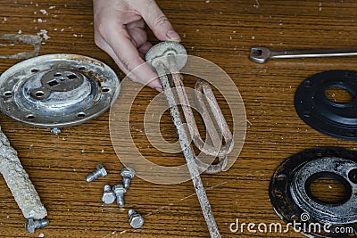 Locksmith performs inspection, disassembly and fault finding of the boiler Stock Photo