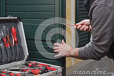 Locksmith repair the door lock Stock Photo