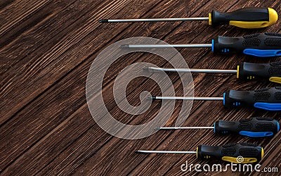 Locksmith`s working tool. Mechanical assembly and disassembly tool. Different screwdrivers on a wooden surface Stock Photo