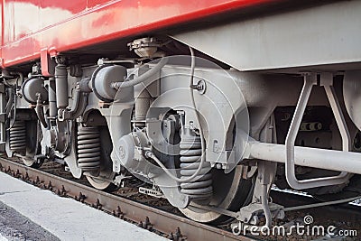 Locomotive on railway station, iron train wheels mechanism close up, steel rail wheel construction, railroad wagon part Editorial Stock Photo