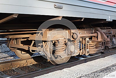 Locomotive on railway station, iron train wheels mechanism close up, steel rail wheel construction, railroad wagon part Editorial Stock Photo