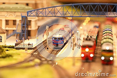 Locomotive with wagons at the railway station. Landscape layout with railroad, cars, residential and industrial buildings. Editorial Stock Photo