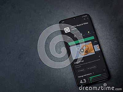 VSCO - Photo and Video Editor app play store page on smartphone on a marble stone background Editorial Stock Photo