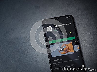 VSCO - Photo and Video Editor app play store page on smartphone on a marble stone background Editorial Stock Photo