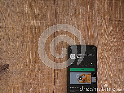 VSCO - Photo and Video Editor app play store page on mobile smartphone on wooden background Editorial Stock Photo