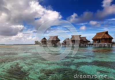 Lodges over transparent quiet sea water- tropical paradise, Maldives Stock Photo