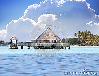 Lodges over transparent quiet sea water- tropical paradise, Stock Photo