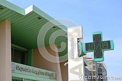 Lodi hospital. Entrance to the modern green painted hospital. Pharmacy cross sign Editorial Stock Photo
