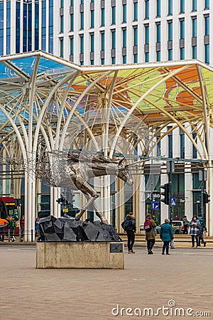 Steel sculpture of a unicorn half melting in the air by Tomohiro Inaba at city center next to Editorial Stock Photo