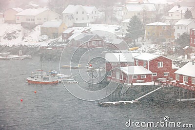 Reine fishing village on Lofoten islands with red rorbu houses in winter with snow. Lofoten islands, Norway, Europe Stock Photo