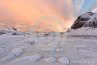 Lofoten Islands in Norway and their beautiful winter scenery at sunset. Idyllic landscape with snow covered beach. Tourist attract Stock Photo