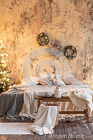 Loft apartments, Christmas tree wreath. Bed in the bedroom, high large Windows Stock Photo