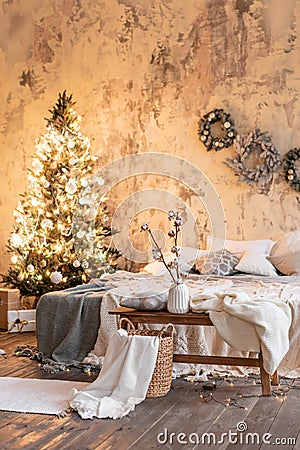 Loft style apartments, Christmas tree wreath. Bed in the bedroom, high large Windows Stock Photo