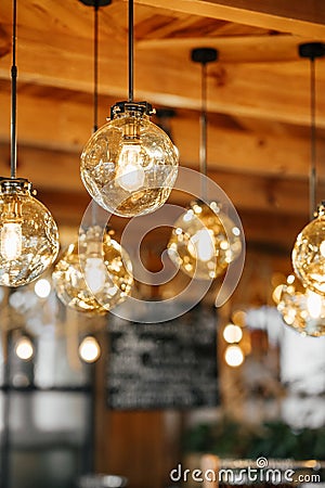 Loft-style luminaires in the interior of a modern cafe. Stock Photo