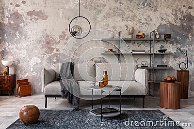 Loft style of modern apartment with grey design sofa, coffee table, bookstand, pedant lamp, carpet, decoration and elegant Stock Photo