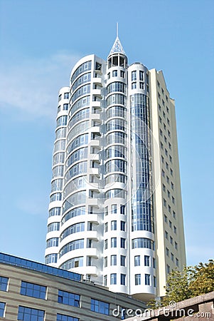 The lofty white building is against light blue sky Stock Photo