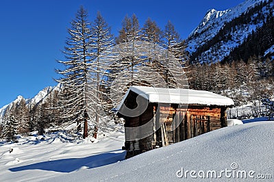 Log cabin in the mountains in winter Stock Photo