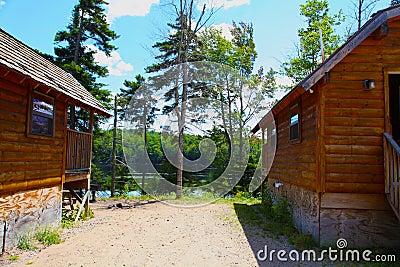 Log cabins in the woods by a lake Stock Photo