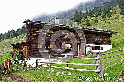 Log home on Austrian mountain slope Stock Photo