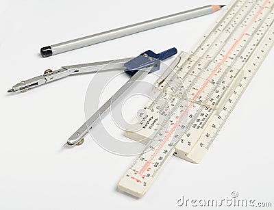 Logarithmic ruler, compasses, pencil on a white background . Stationery for engineers and students Stock Photo