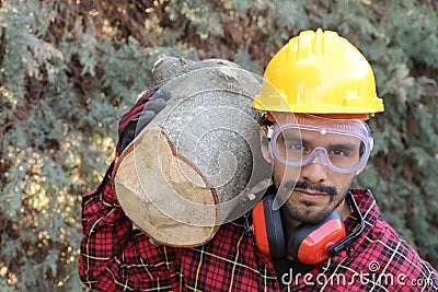 Logger holding heavy trunk in the forest Stock Photo