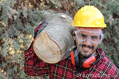 Logger holding heavy trunk in the forest Stock Photo