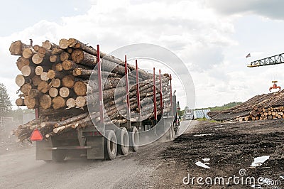 Logging truck logs at mill Stock Photo