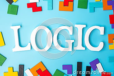 LOGIC text with colorful wood puzzle pieces, geometric shape block on blue background. Concepts of logical thinking, Conundrum, Stock Photo