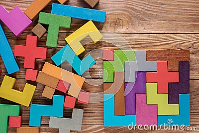 Logical tasks composed of colorful wooden shapes. Stock Photo