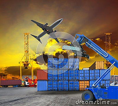 Logistic business working in container shipping yard with dusky sky and jet plane cargo flying above use for land to air transport Stock Photo