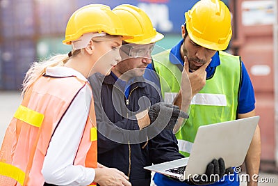 Logistic team worker working together to brainstorming analysis the problem report from laptop computer at port warehouse cargo Stock Photo