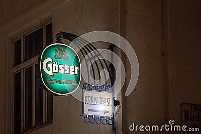 Logo of Gosser beer in front of a local bar and cafe in Vienna. Gosser bier is an iconic Austrial light beer, Helles type Editorial Stock Photo