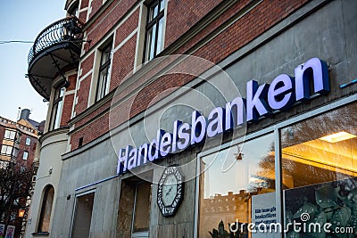 The logo of the Handelsbanken bank on a street in Stockholm, Sweden during the early twilight Editorial Stock Photo