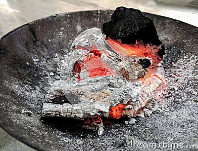 Logs burn in the campfire. Close-up of firewood, coals Stock Photo