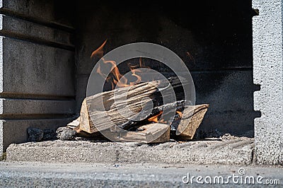 Logs in outside fire grill Stock Photo