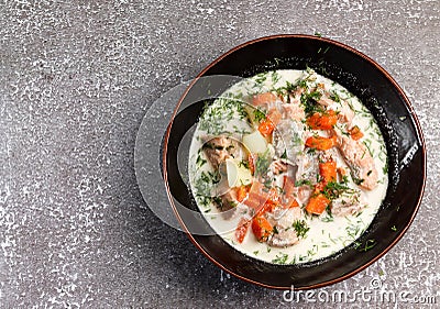 Lohikeitto, finnish traditional salmon soup in a bowl on a dark background Stock Photo