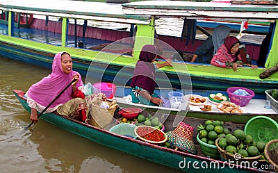 A mother is selling fruits and vegetables at the Lok Baintan floating market Editorial Stock Photo