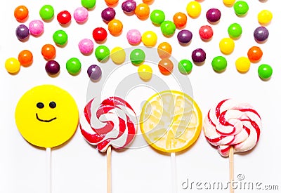 Lollipops, candy smile on, scattered round pills Stock Photo