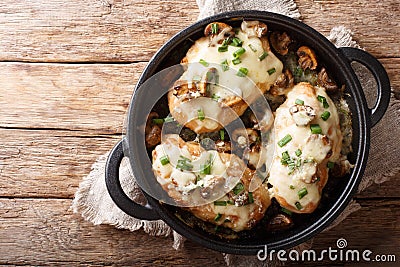 Lombardy Chicken breasts cooked with mushrooms, green onions, mozzarella cheese and parmesan closeup. horizontal top view Stock Photo