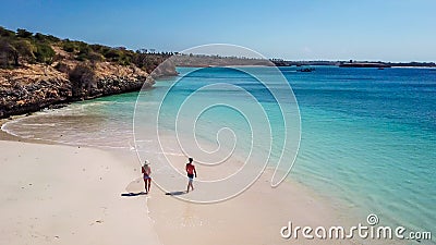 Lombok - A drone shot of a couple playing at the seashore of Pink Beach Stock Photo