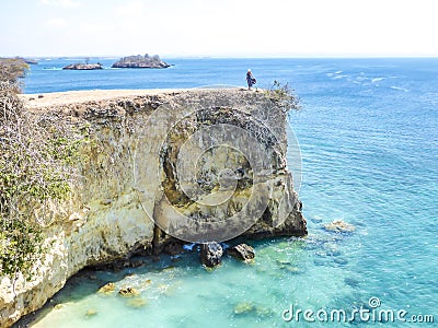 Lombok - A girl and the Pink Beach Cliff Stock Photo