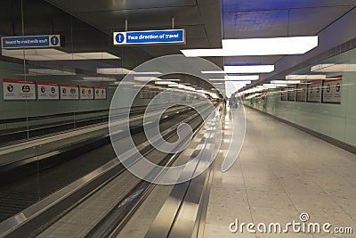 Heathrow Airport terminal walkway to boarding gates. Editorial Stock Photo