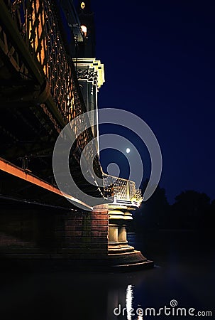 Bridge rests quitely as moon watches on Stock Photo